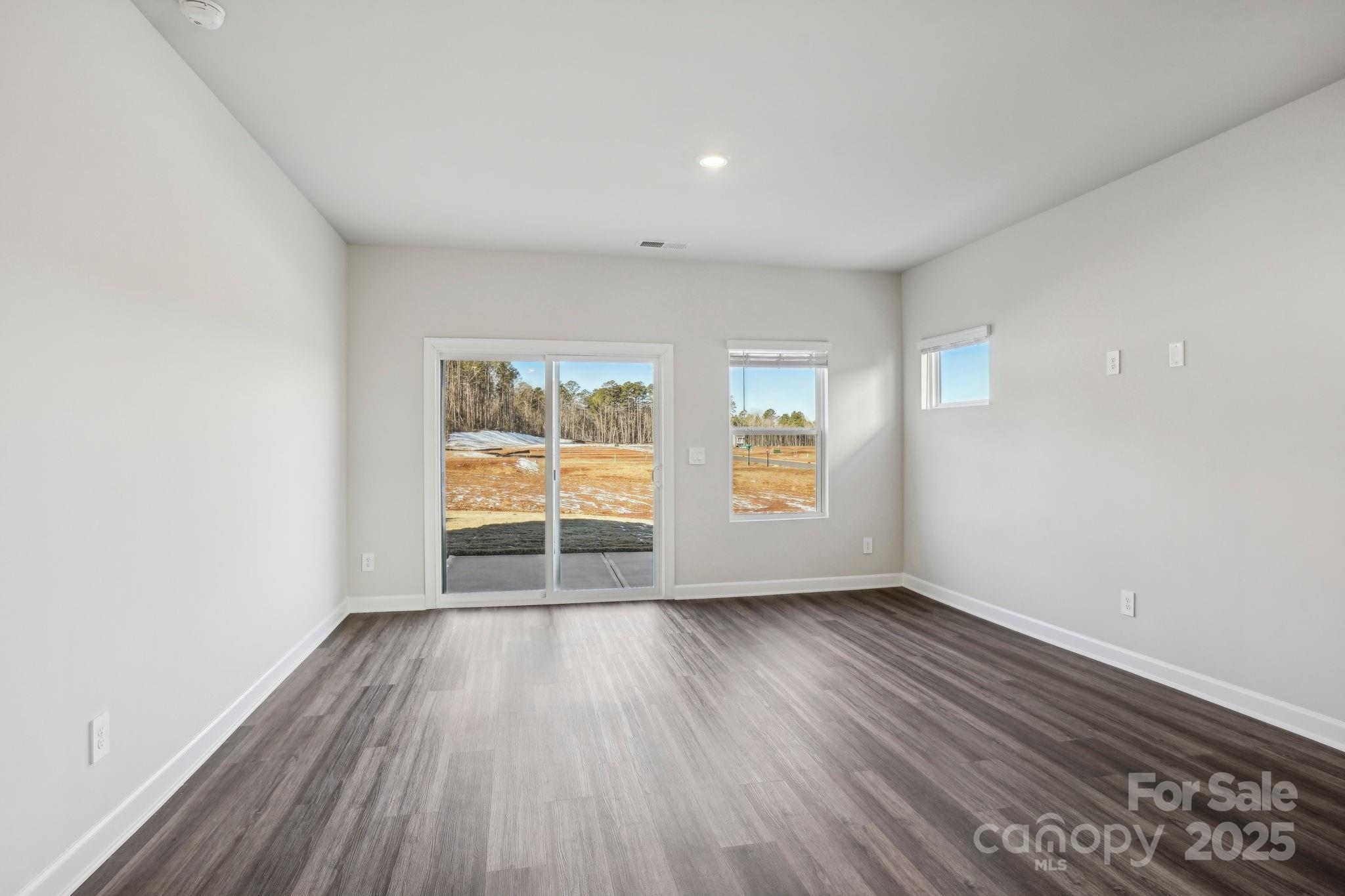 1265 30th St Lane Northeast Conover, NC 28613 - Photo 3 of 24 wooden floor in an empty room with a window