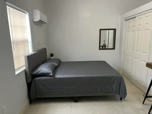 a bedroom with a bed and a window