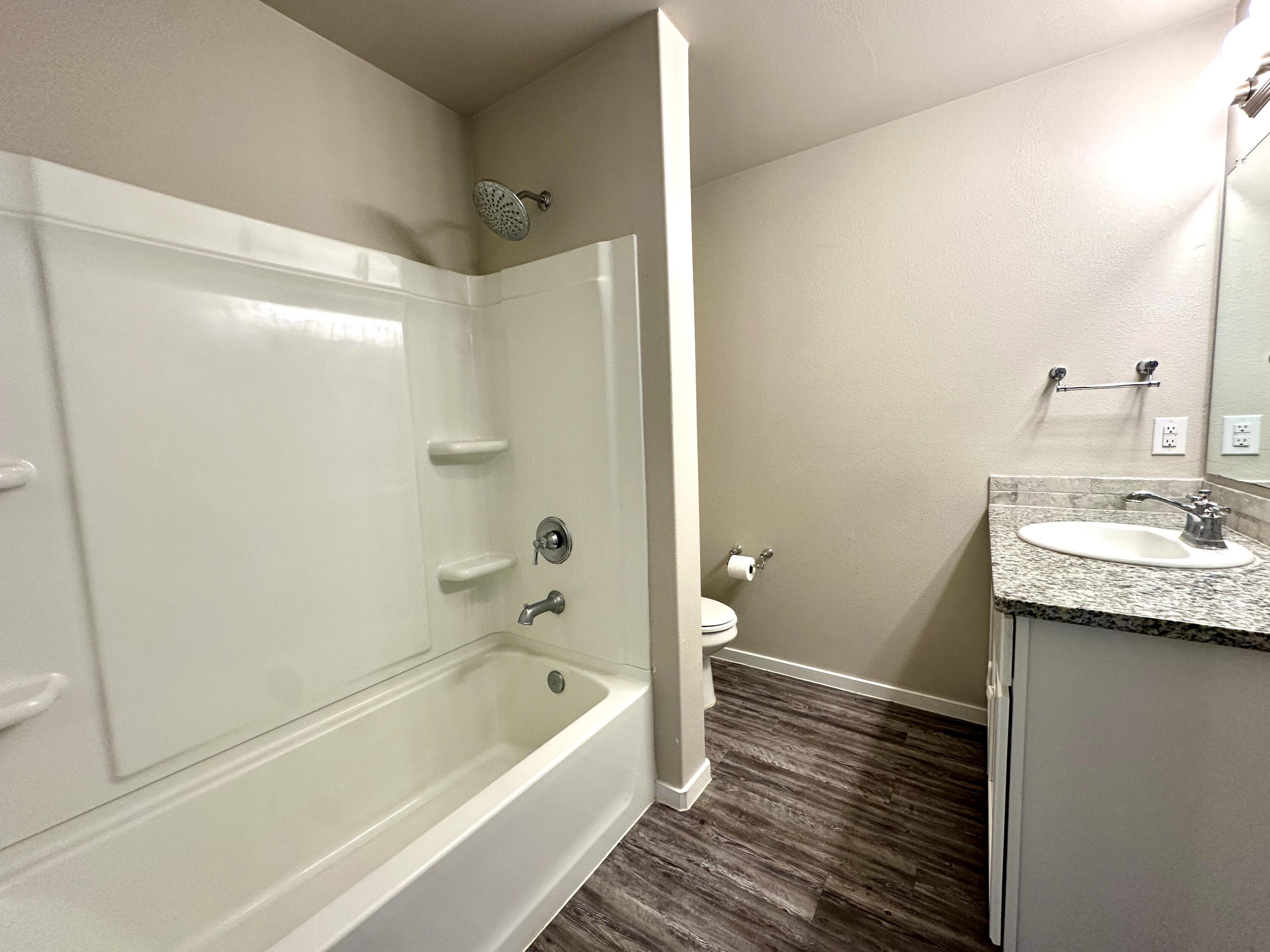 7526 31st Place Lubbock, TX 79407 - Photo 11 of 14 a bathroom with a bathtub a sink and a toilet