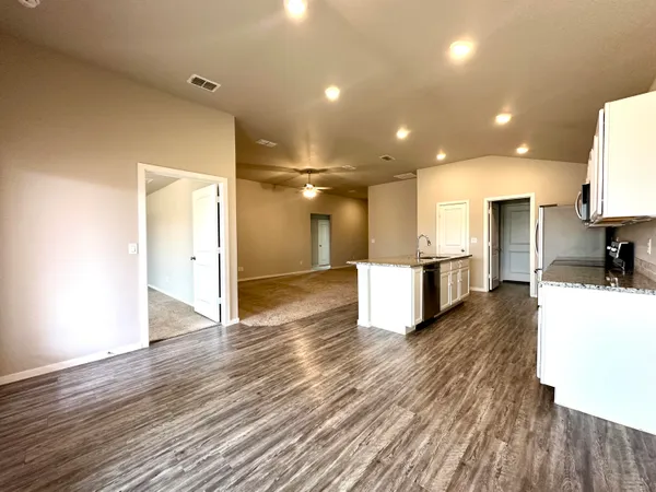 a view of kitchen with cabinets and wooden floor