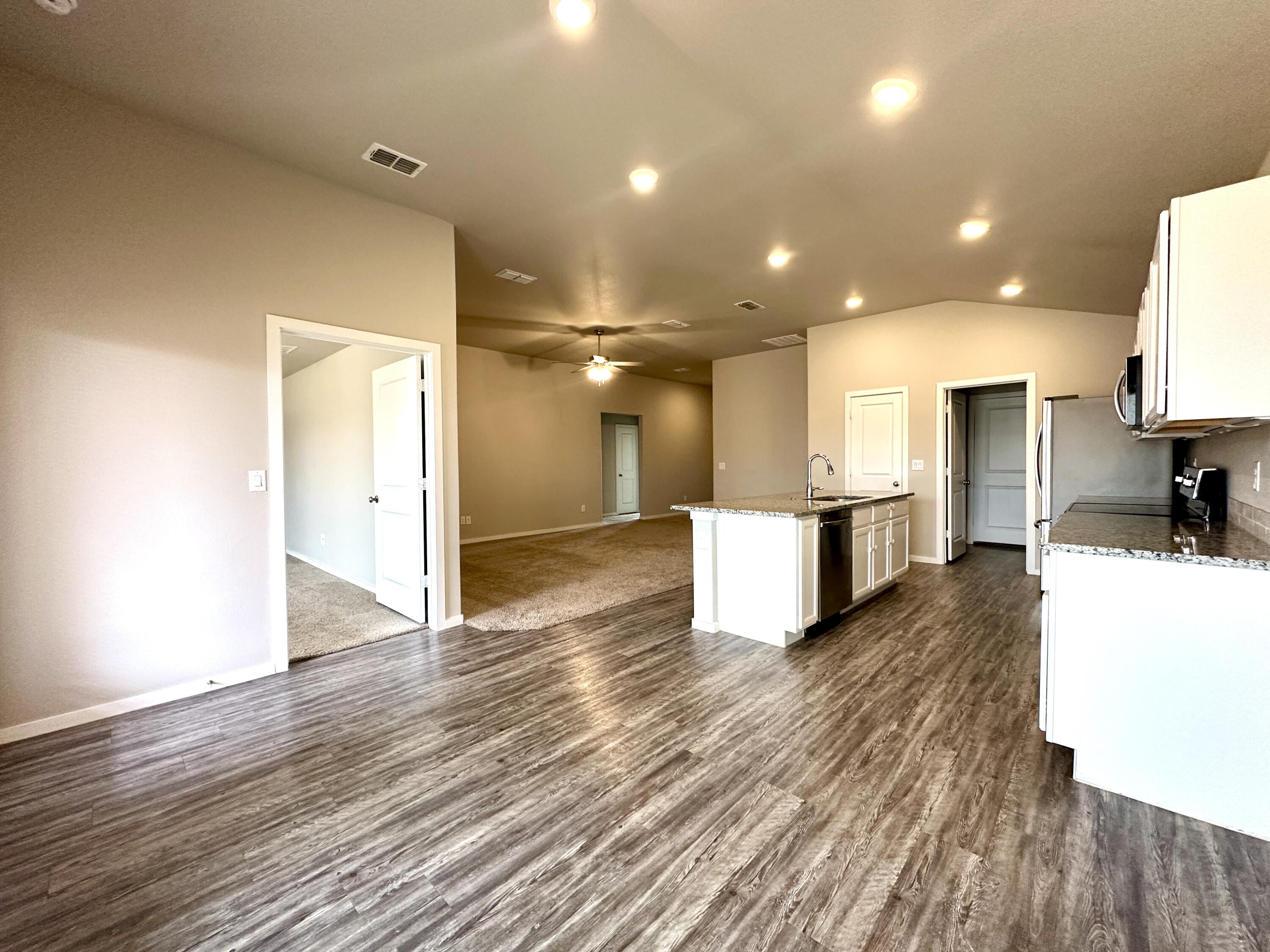 7526 31st Place Lubbock, TX 79407 - Photo 4 of 14 a view of kitchen with cabinets and wooden floor