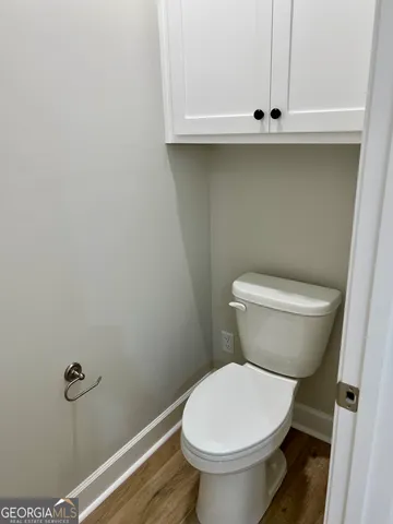 a white toilet sitting next to a sink