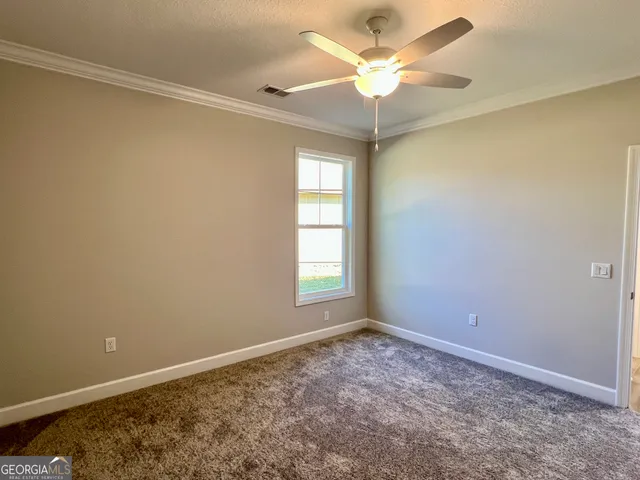 a view of room with window and ceiling fan