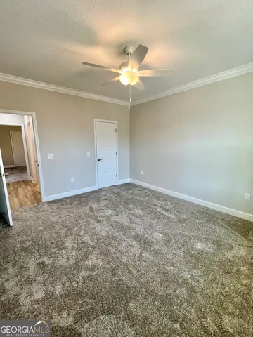 an empty room with a ceiling fan and a window
