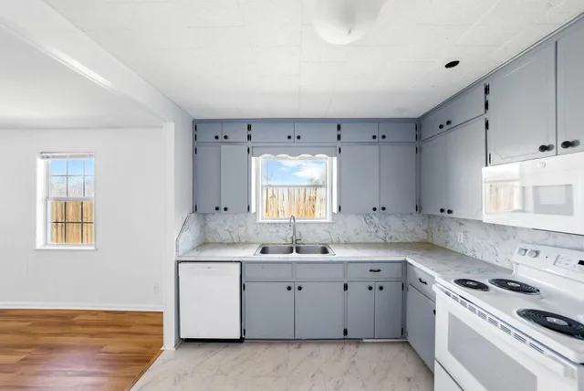 a kitchen with a sink stove and cabinets