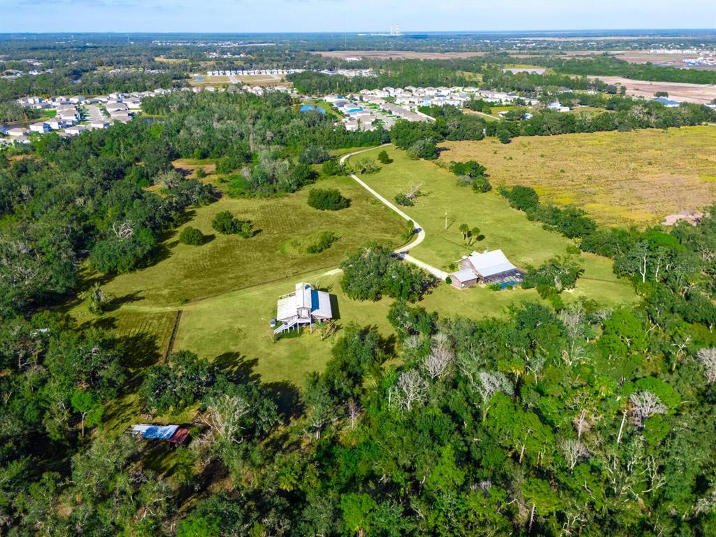 2405 North Rye Road Parrish, FL 34219 - Photo 3 of 5 an aerial view of residential houses with outdoor space and trees