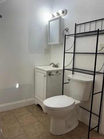 a white toilet sitting next to a bathroom sink
