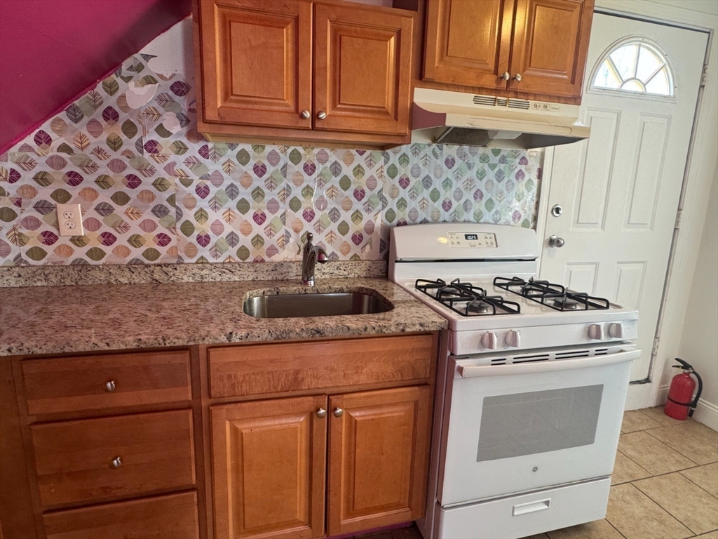 61 Crescent Avenue, Unit 2 Chelsea, MA 02150 - Photo 2 of 16 a stove top oven sitting inside of a kitchen