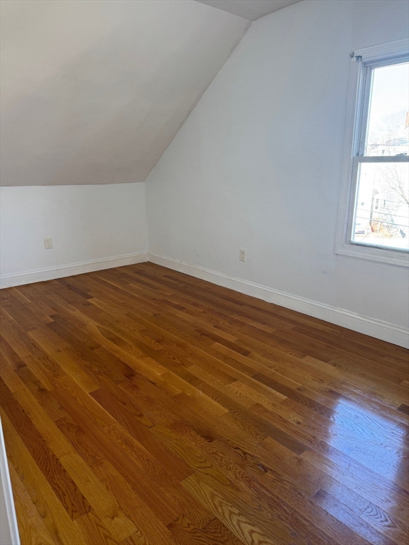 61 Crescent Avenue, Unit 2 Chelsea, MA 02150 - Photo 3 of 16 an empty room with wooden floor and windows