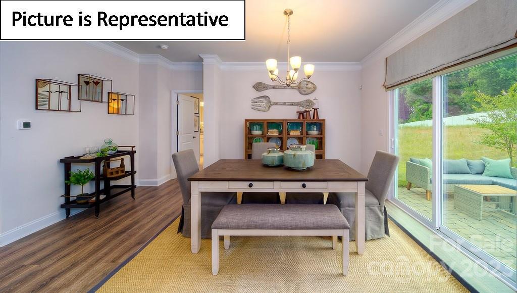 4182 Millstream Road Denver, NC 28037 - Photo 12 of 29 a dining room with furniture a rug and a chandelier