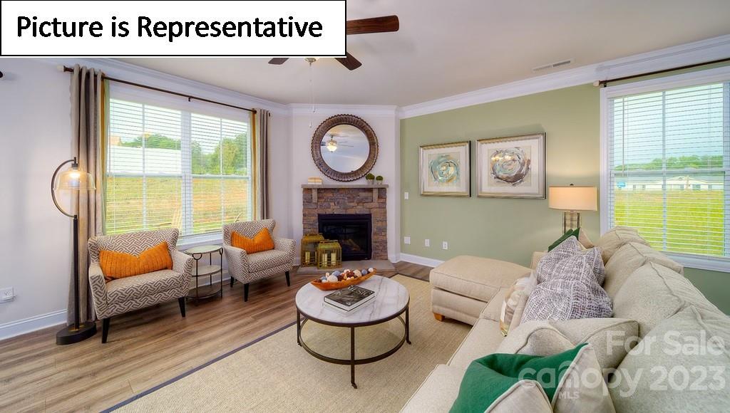 4182 Millstream Road Denver, NC 28037 - Photo 18 of 29 a living room with furniture and a fireplace
