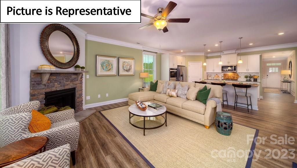 4182 Millstream Road Denver, NC 28037 - Photo 19 of 29 a living room with furniture and a fireplace