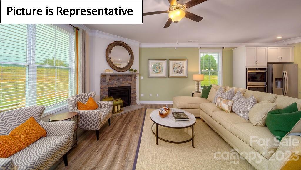 4182 Millstream Road Denver, NC 28037 - Photo 20 of 29 a living room with furniture a fireplace and a large window