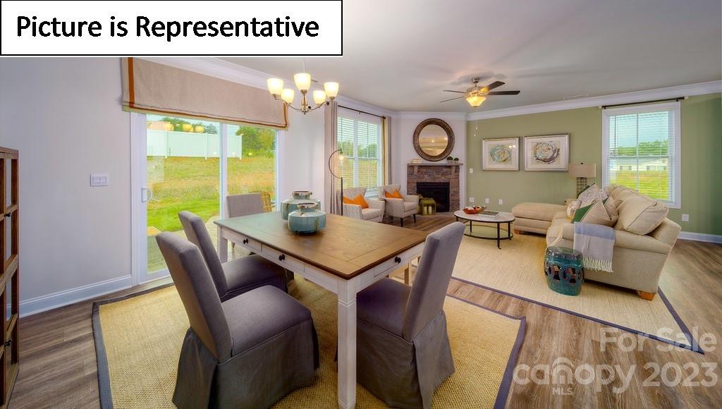 4182 Millstream Road Denver, NC 28037 - Photo 22 of 29 a view of a dining room with furniture a chandelier and wooden floor