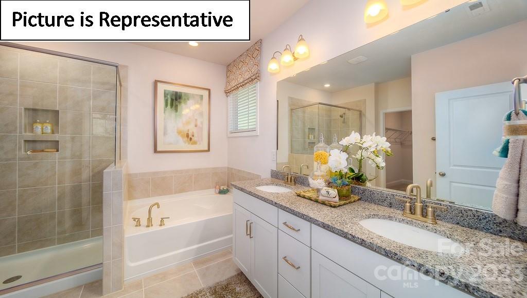4182 Millstream Road Denver, NC 28037 - Photo 27 of 29 a bathroom with a granite countertop sink a large mirror and shower