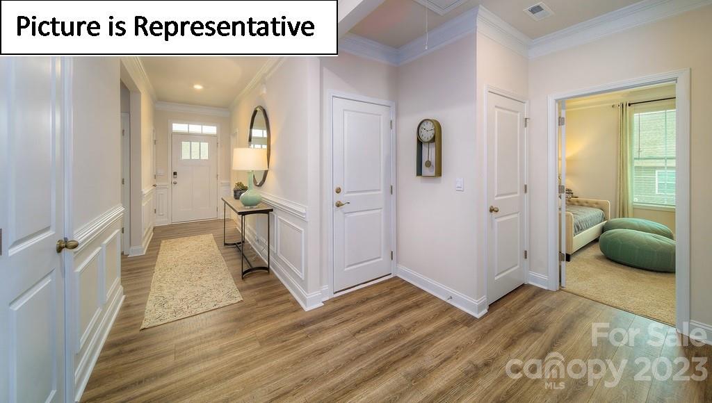 4182 Millstream Road Denver, NC 28037 - Photo 3 of 29 a view of a hallway with wooden floor and furniture