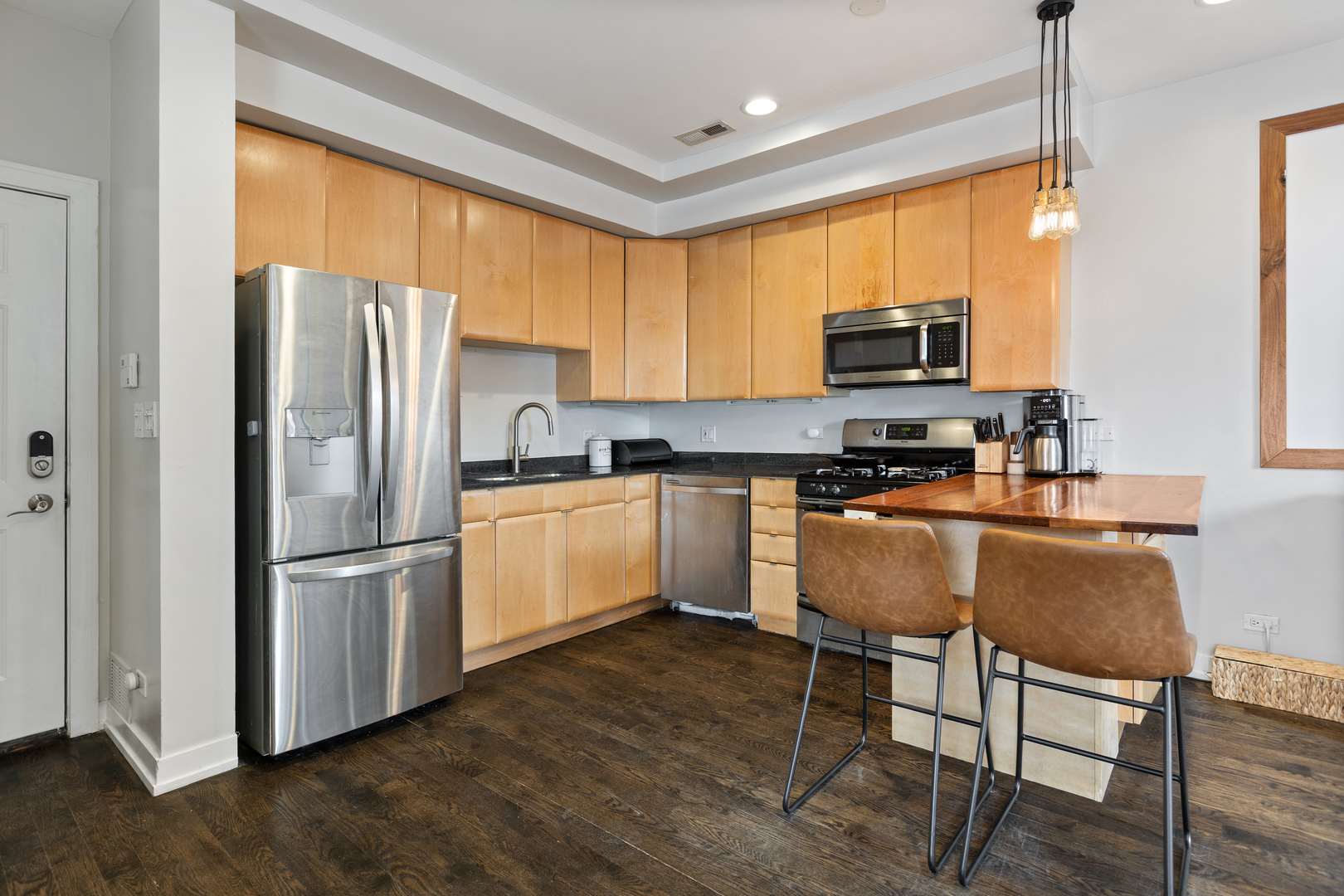 417 North Noble Street, Unit 5 Chicago, IL 60642 - Photo 4 of 15 a kitchen with stainless steel appliances granite countertop a refrigerator a sink dishwasher a stove and a refrigerator with wooden floor