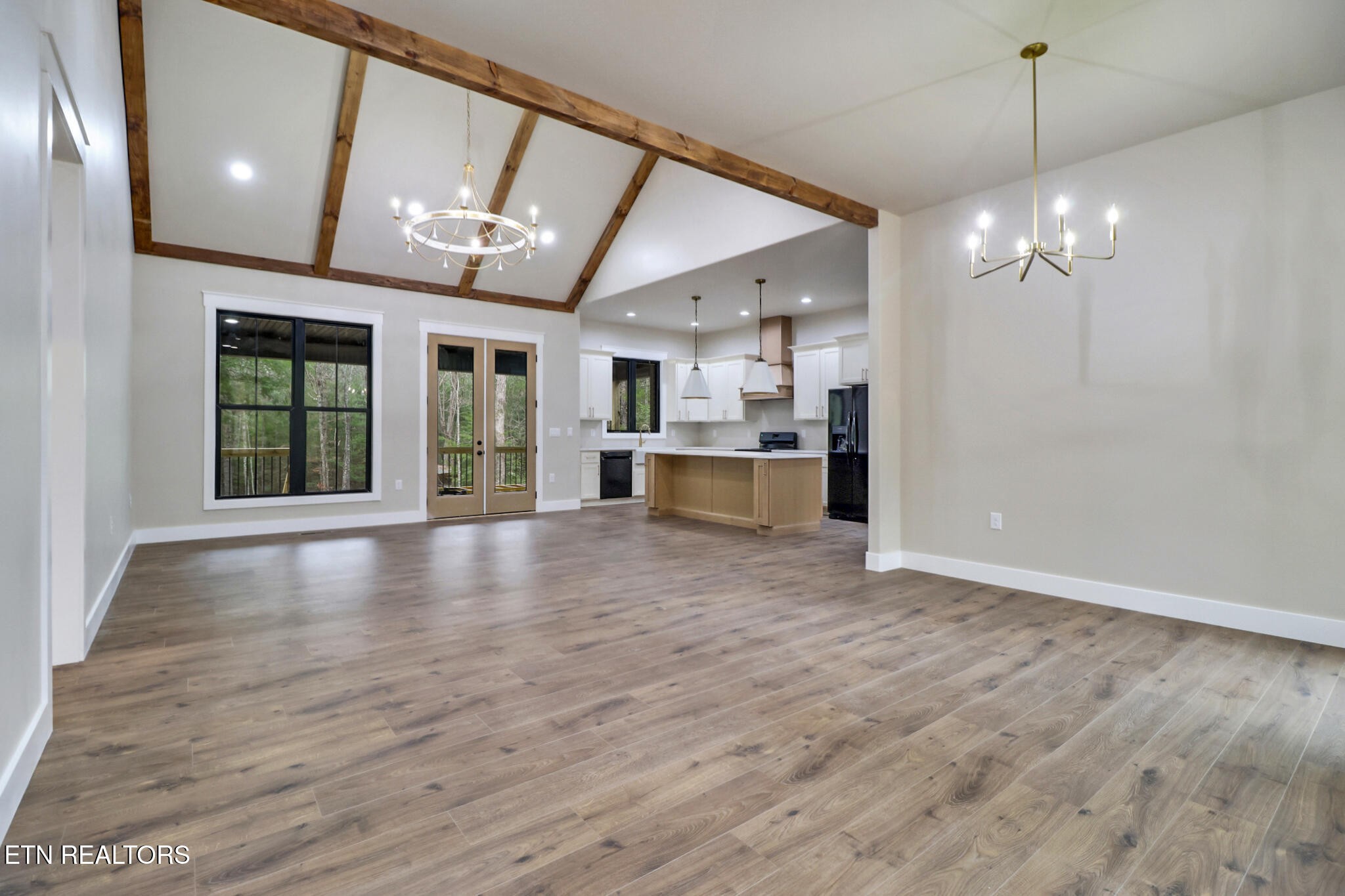 1440 Model Farm Road Jamestown, TN 38556 - Photo 11 of 35 a view of an empty room with kitchen and chandelier fan