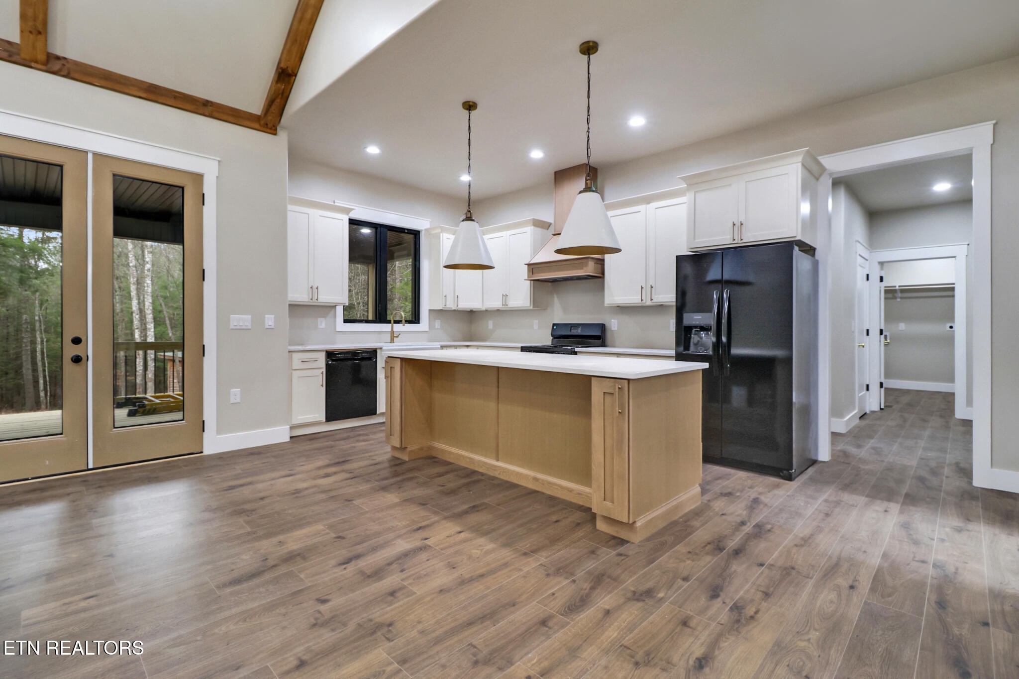 1440 Model Farm Road Jamestown, TN 38556 - Photo 15 of 35 a large kitchen with stainless steel appliances kitchen island a large counter top and wooden floors