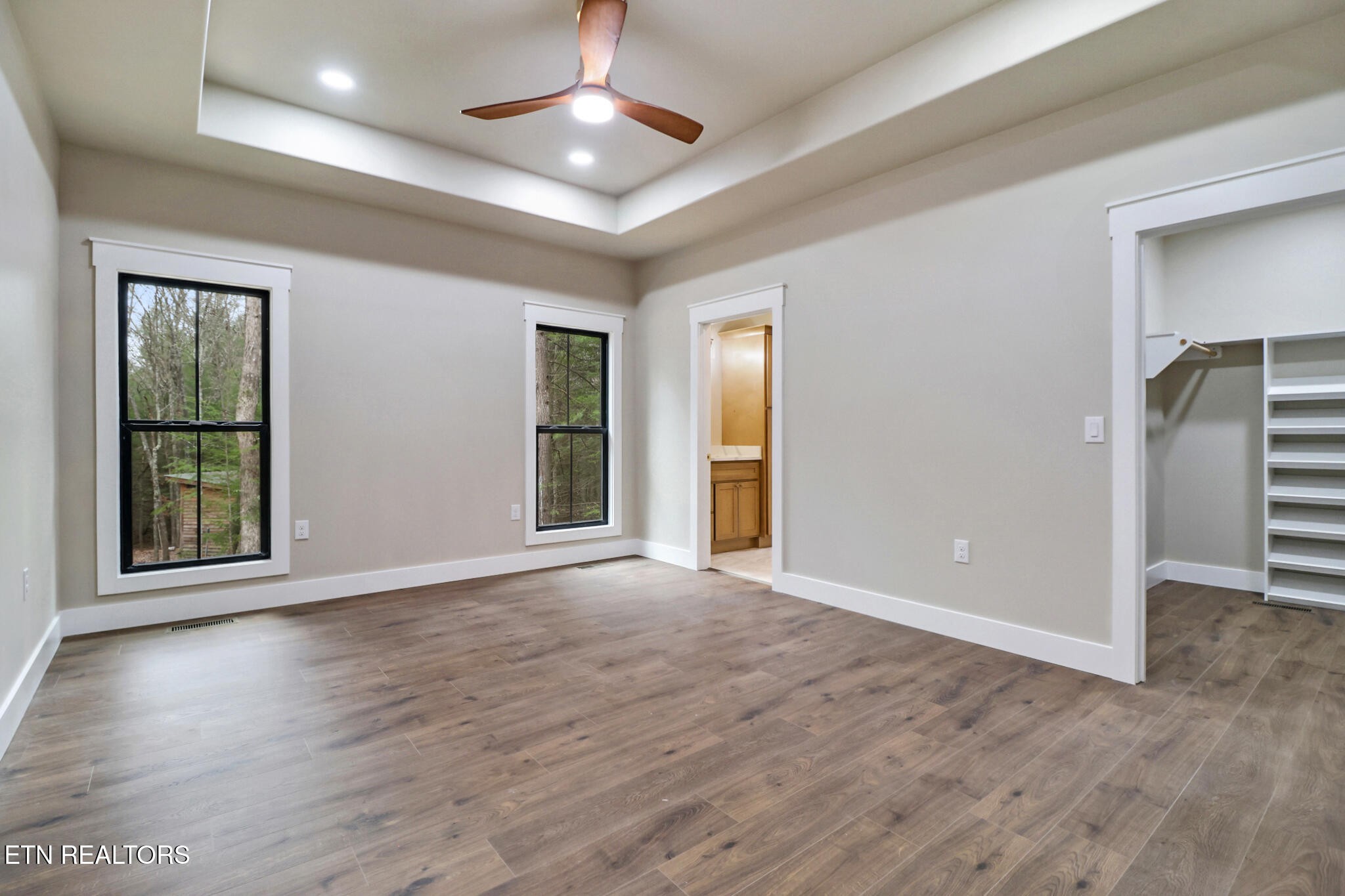 1440 Model Farm Road Jamestown, TN 38556 - Photo 19 of 35 an empty room with wooden floor chandelier and windows