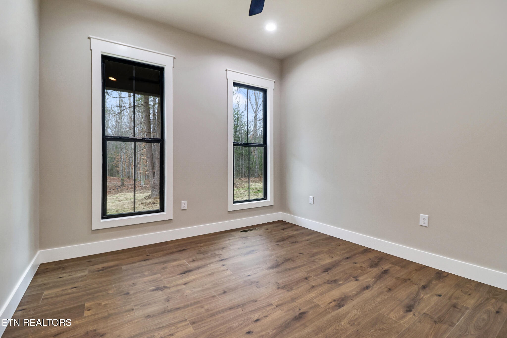 1440 Model Farm Road Jamestown, TN 38556 - Photo 23 of 35 a view of an empty room with wooden floor and windows