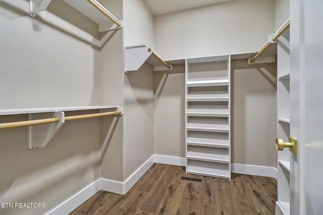a view of walk in closet with empty racks