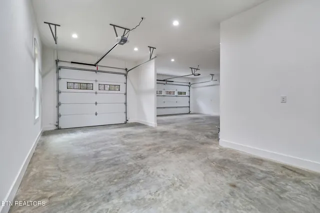 an empty room with a cabinet and mirrors