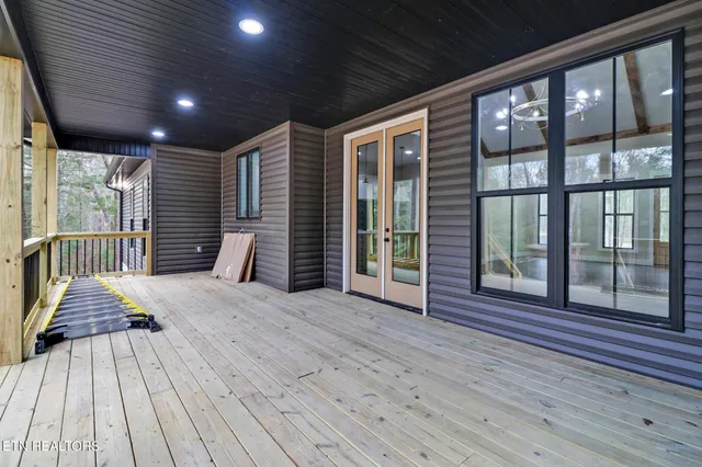 a view of outdoor space with wooden floor and windows