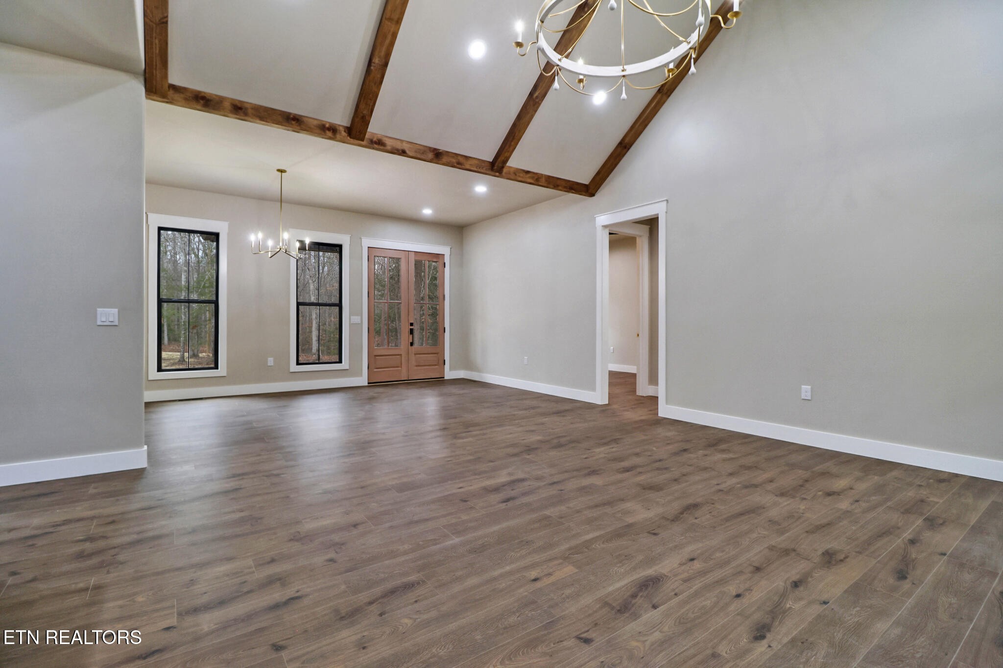 1440 Model Farm Road Jamestown, TN 38556 - Photo 10 of 35 an empty room with wooden floor and windows