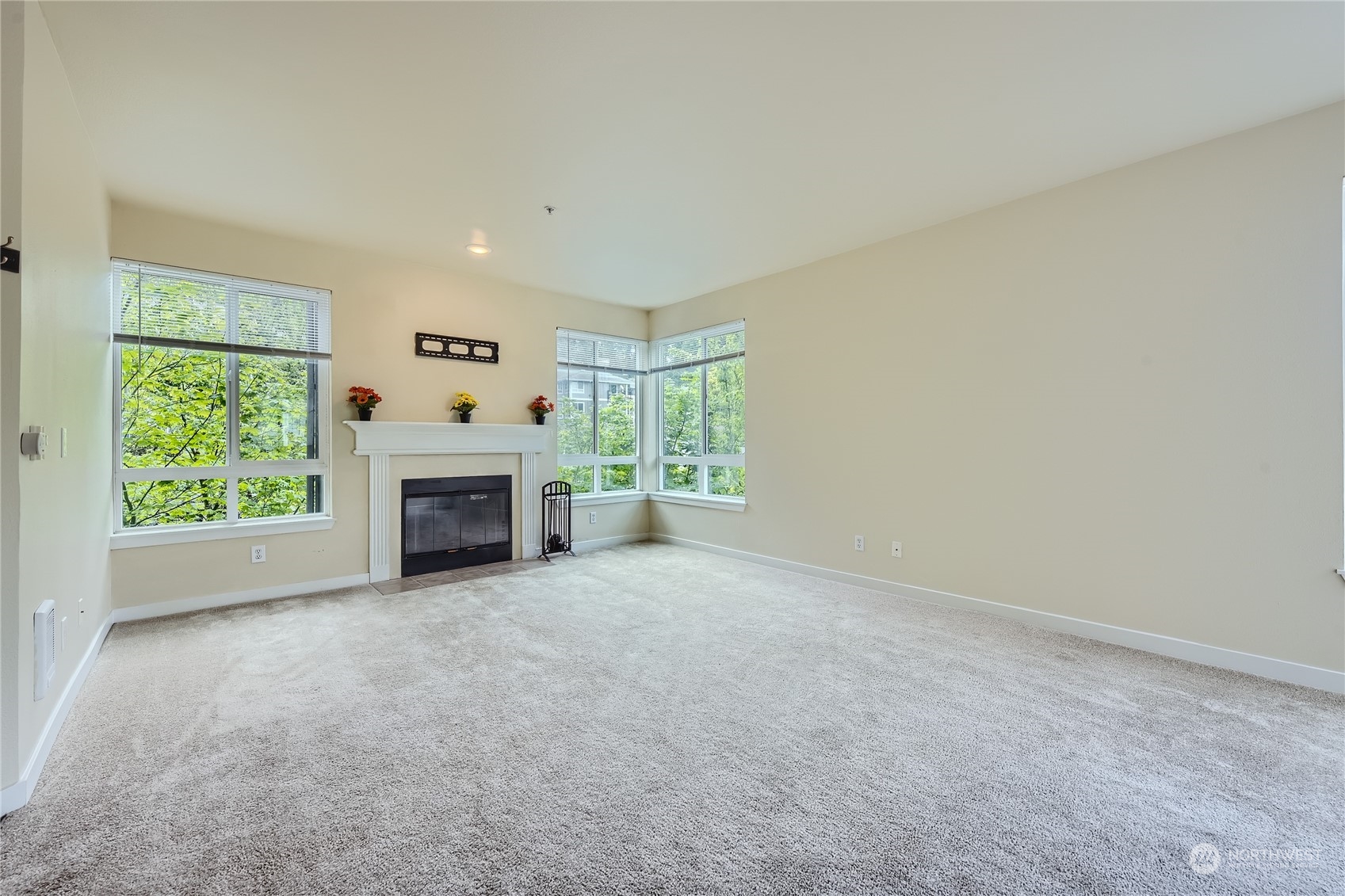 3901 243rd Place Southeast, Unit O203 Bothell, WA 98021 - Photo 2 of 11 an empty room with furniture and a fireplace