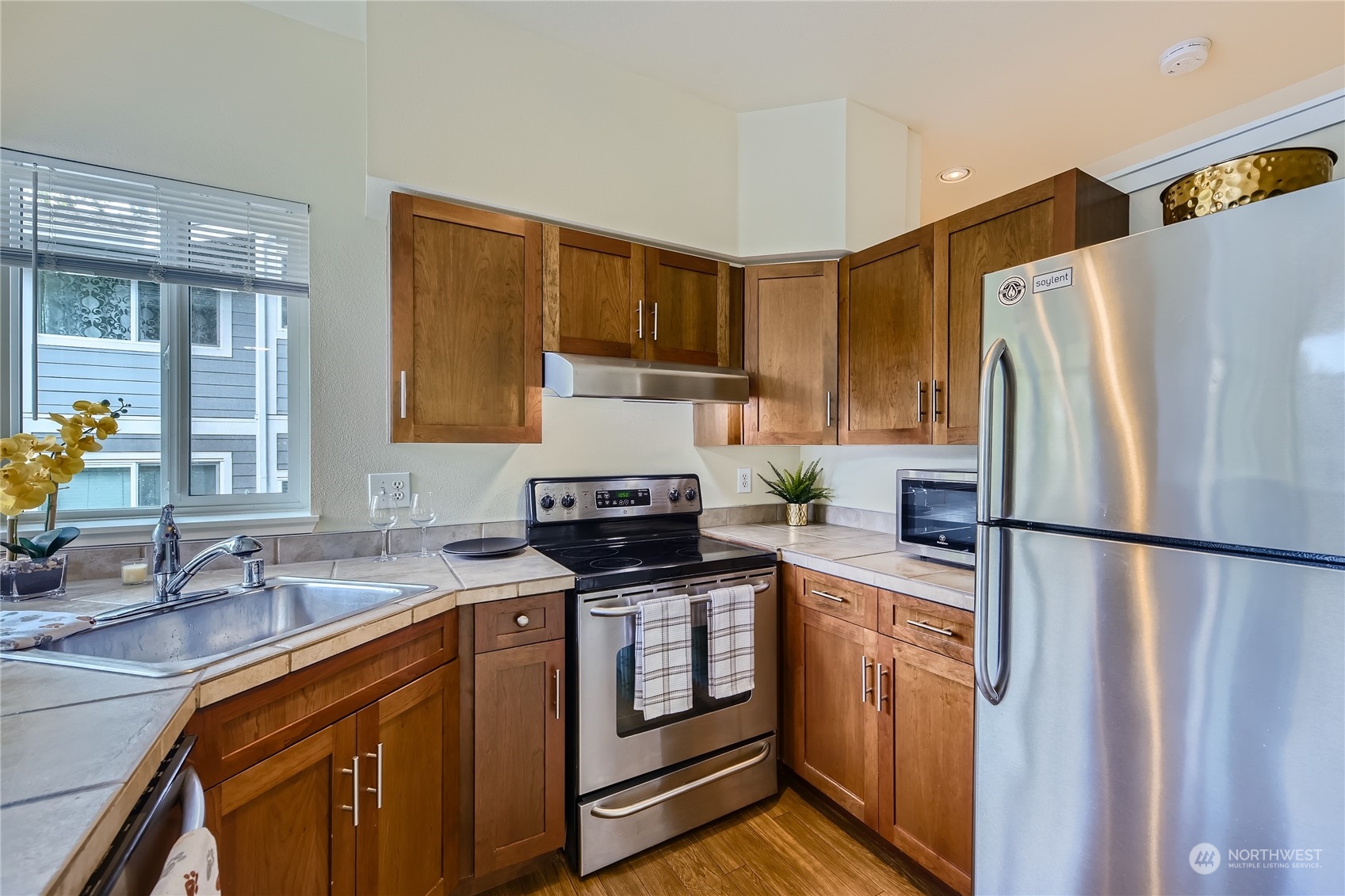 3901 243rd Place Southeast, Unit O203 Bothell, WA 98021 - Photo 5 of 11 a kitchen with a refrigerator sink and stove
