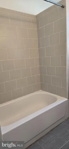 a bathroom with bathtub and shower