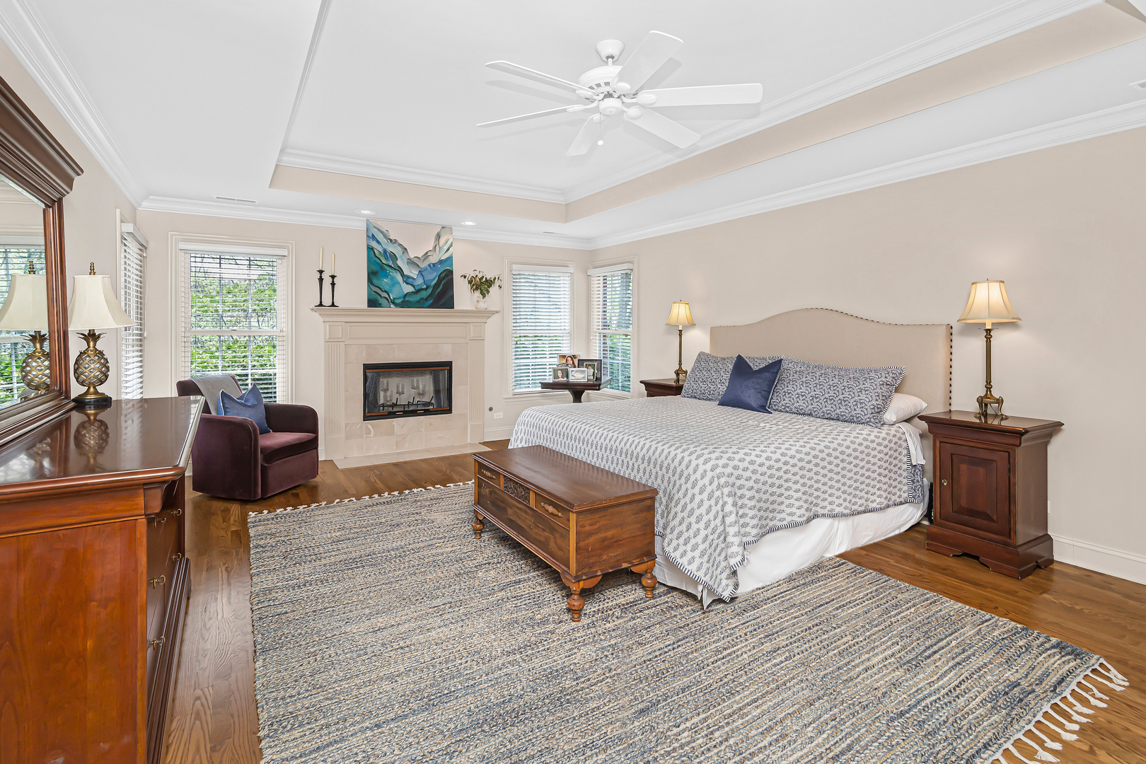 300 Walnut Street Winnetka, IL 60093 - Photo 17 of 28 a bedroom with a bed wooden floor and a fireplace