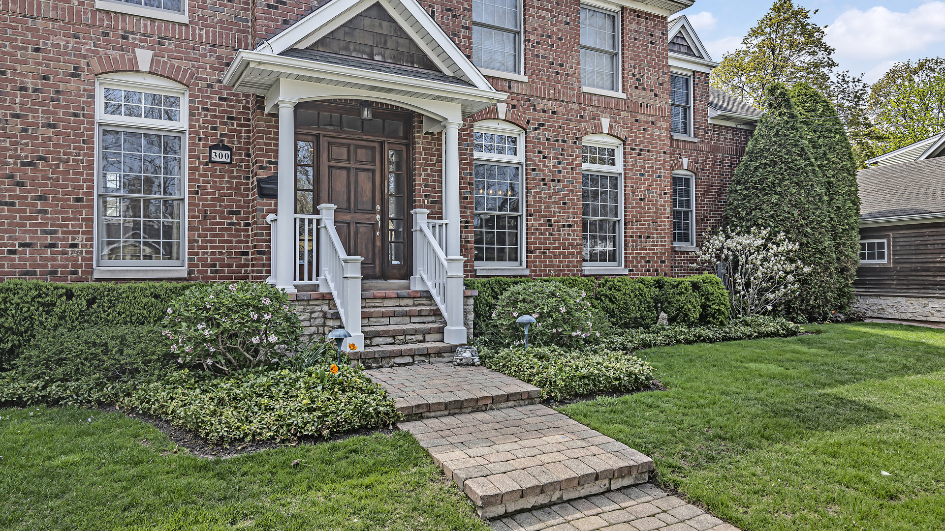 300 Walnut Street Winnetka, IL 60093 - Photo 2 of 28 a front view of a house with garden