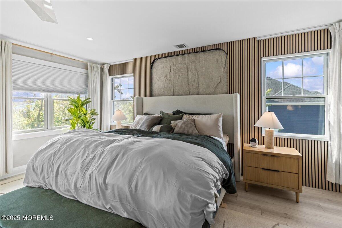 1608 East Street Point Pleasant Beach, NJ 08742 - Photo 16 of 51 a bed sitting in a bedroom next to a window