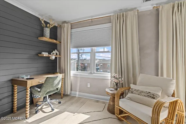 a living room with a bed furniture and a large window