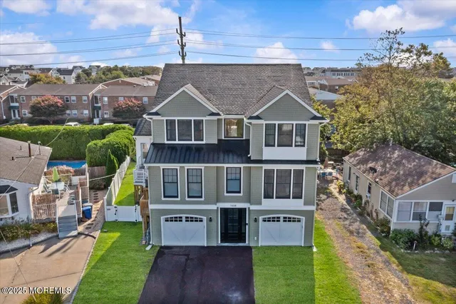 an aerial view of residential houses with yard