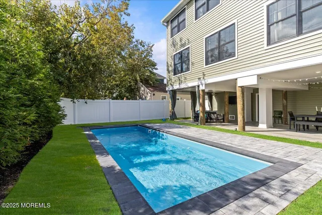 a view of an white house with a swimming pool