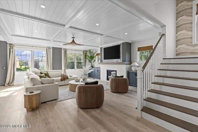 a living room with furniture fireplace and a flat screen tv