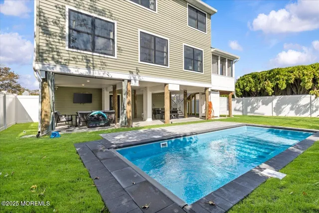 a view of a house with a yard patio and swimming pool