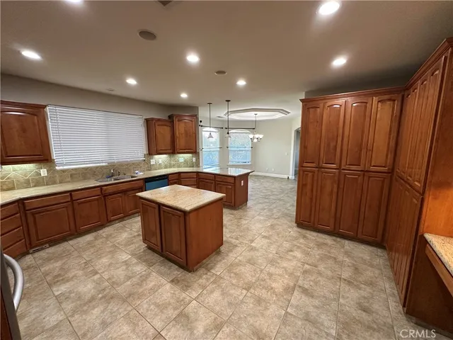 a large kitchen with wooden cabinets and a sink