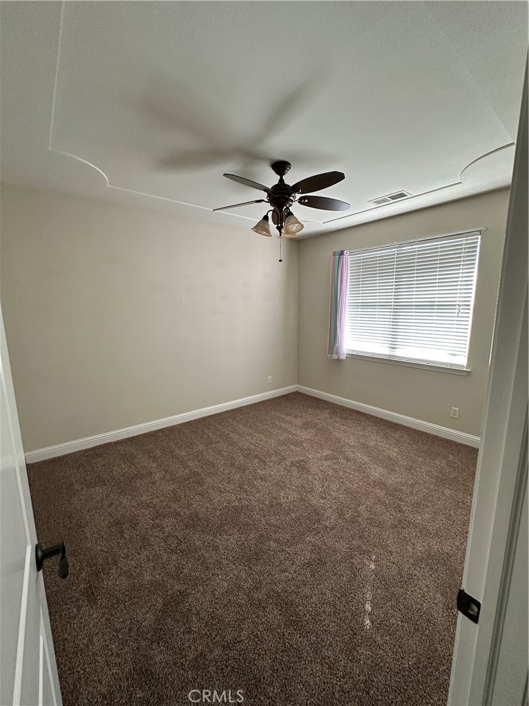 3119 Lorrie Court Merced, CA 95348 - Photo 18 of 38 an empty room with windows and fan