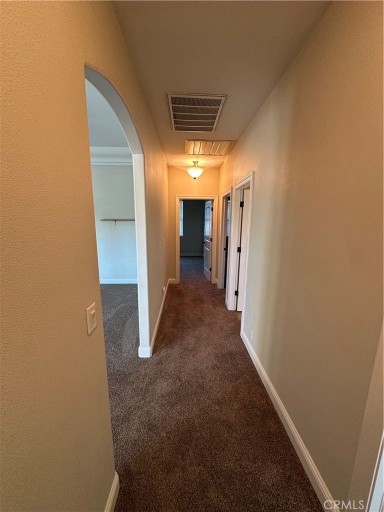 3119 Lorrie Court Merced, CA 95348 - Photo 19 of 38 a view of a hallway with wooden shelves