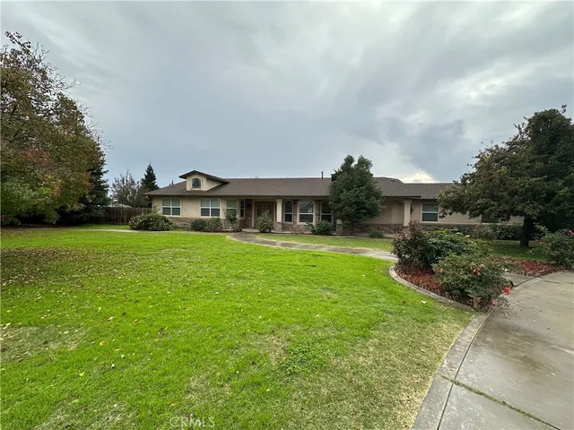 a front view of house with yard and green space