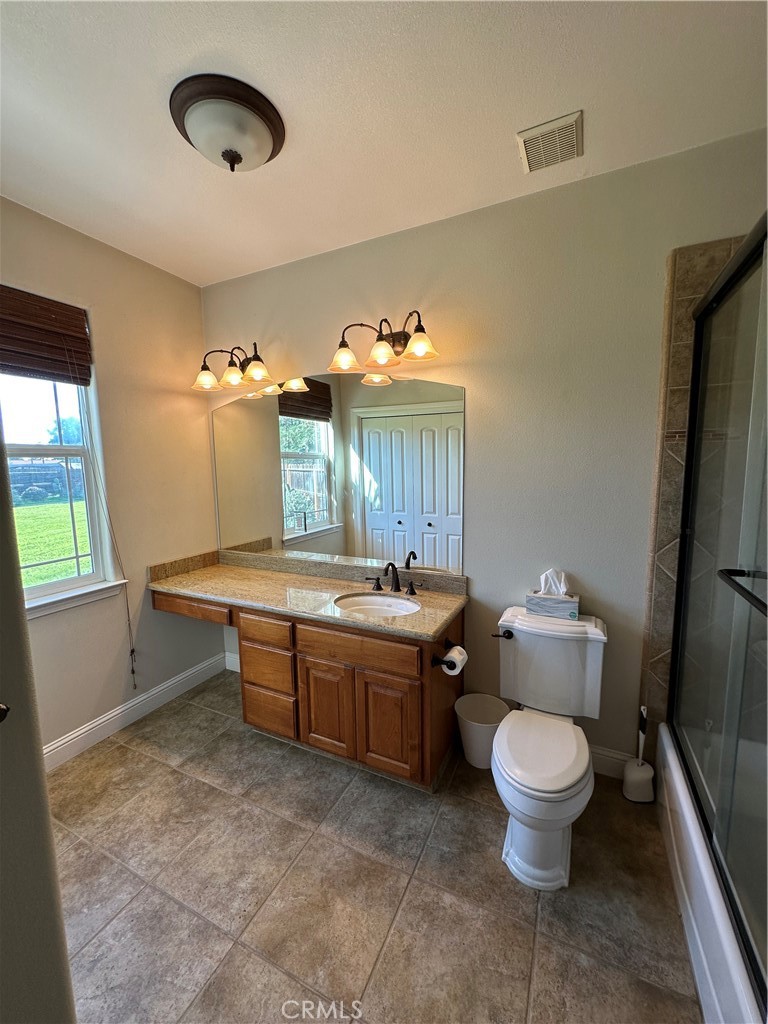 3119 Lorrie Court Merced, CA 95348 - Photo 22 of 38 a room with a chair and a chandelier