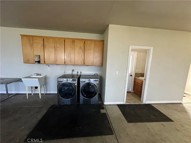 a view of a hallway with washer and dryer