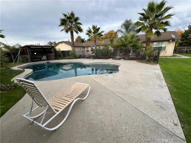 a view of a patio with a table and chairs