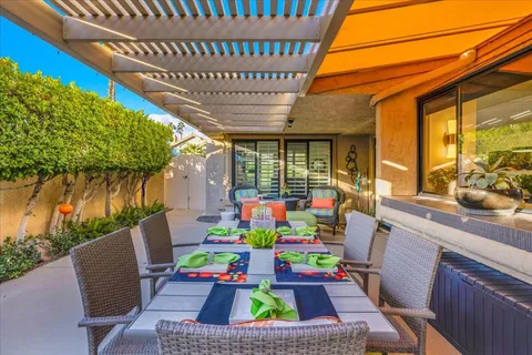 a view of a house with backyard sitting area and garden