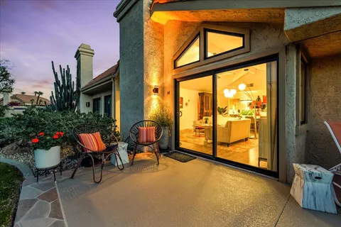 a view of swimming pool with outdoor seating and plants