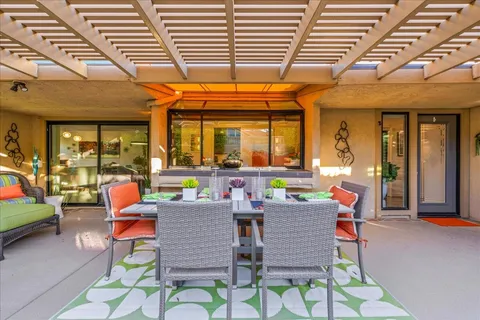 a patio with a table and chairs